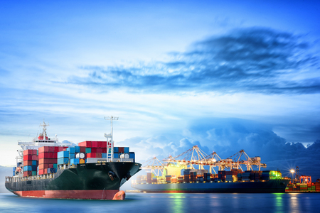 Logistics and transportation of International Container Cargo ship with ports crane bridge in harbor for logistics import export background and transportation industry.の写真素材