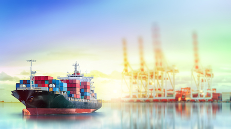 Logistics and transportation of International Container Cargo ship with working crane bridge in seaport for logistic import export background and transport industry.の写真素材