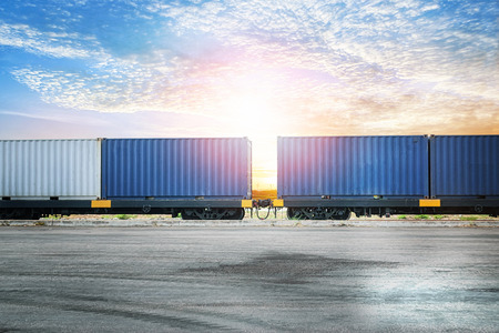 Industrial container yard at sunset sky for logistic import export backgroundの写真素材
