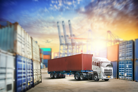 Cargo transportation unloading container trucks in warehouse logistics import export backgroundの写真素材