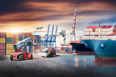 Business logistics and transportation concept of containers cargo freight ship and cargo plane with working crane in shipyard at sunset sky, logistic import export and transport industry backgroundの写真素材