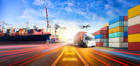 Global business logistics import export and container cargo freight ship during loading at industrial port by port crane, cargo plane, truck on highway with copy space, transportation industry conceptの写真素材