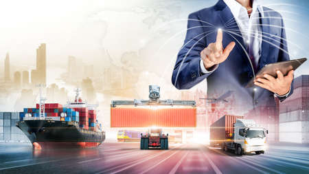 Businessman touching virtual screen world map of Global logistics network distribution, Container cargo freight ship at industrial port for logistics Import export background, Smart technology conceptの写真素材
