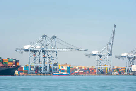 Transport Container Cargo Freight Ship loading and unloading goods containers by harbor crane in shipping port, Logistic Import Export backgroundの写真素材