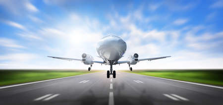 Airplane taking landing and Airport runway at beautiful blue sky, Commercial plane and Travel concept, Aircraft with motion blurred Background, front viewの写真素材