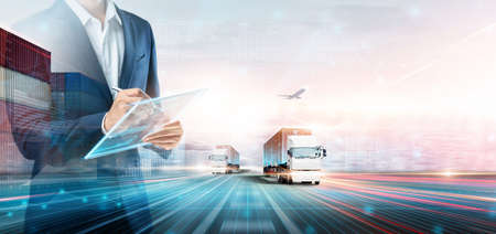 Business and Technology Digital Future of Cargo Containers Logistics Transport Concept, Double Exposure of Business man using Tablet and Freight Truck at Port, Transportation Import Export Backgroundの写真素材