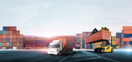 <p>Container handler forklift loading at the docks to truck with stack of colorful containers box background and copy space, Cargo freight shipping import export logistics transportation industry concept</p>の写真素材