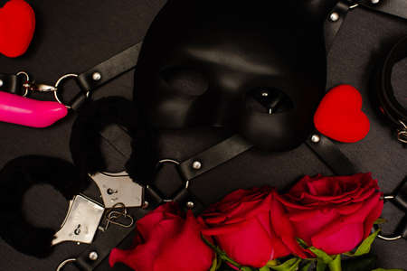 Set of adult toys with red roses on blackの写真素材