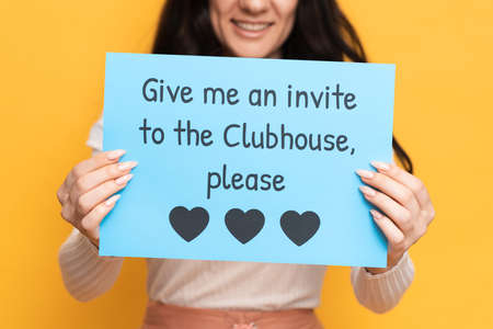 VICHUGA, RUSSIA, February 18, 2021: A young girl holds a sign that reads Give me an invite to the...