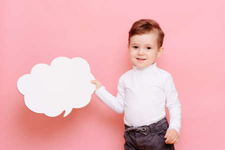 studio portrait of a boy with a blank white board in the shape of a cloudの写真素材