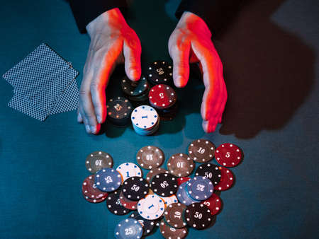 mens hands place a bet with playing chips