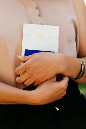 a book in the hands of a young beautiful girlの写真素材