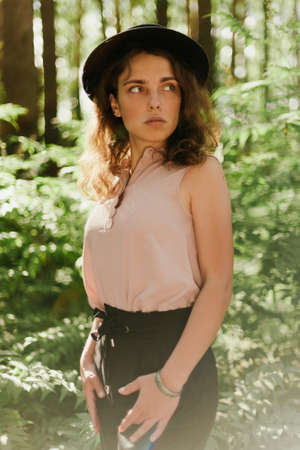 Portrait of a cute girl in a beautiful Park near the treesの写真素材