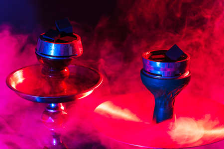 hookah bowl and coals close up on a black background with smokeの写真素材