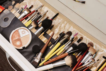 Shooting in a beauty salon. A snapshot of the makeup artists workplace with professional cosmetics and brushes laid out.の写真素材