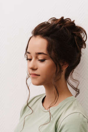Shooting in a beauty salon. Portrait of a young dark-haired girl after visiting a hairdresser and make-up artist. The finished imageの写真素材
