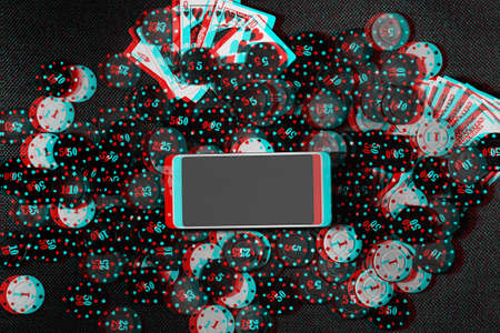 The concept of an online casino: betting chips, money, playing cards and a smartphone with copy...