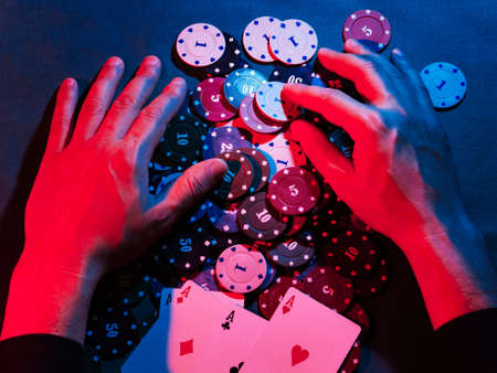 mens hands take away the playing chips placed on the bet. victoryの写真素材