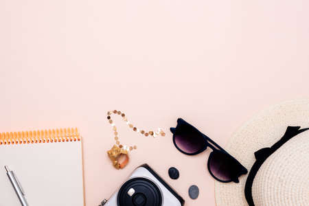 summer travel accessories. camera, hat, glasses and top view on a light background. with space for your textの写真素材