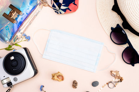 summer travel accessories. womens set of adult toys, camera, hat, glasses, protective mask and gloves on a light background.の写真素材
