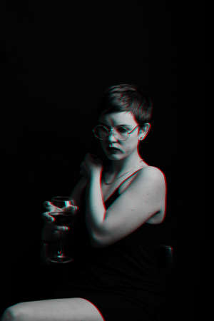 beautiful young girl tries and evaluates red wine. Black and white with glitch effectの写真素材