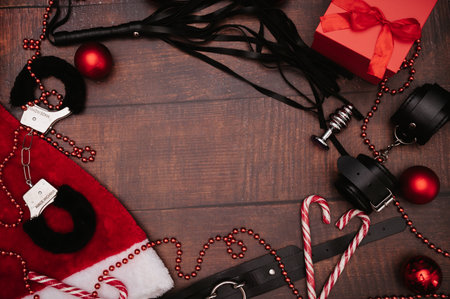 A set of adult BDSM toys with Christmas decor. A frame with space for text. Flatley. Example of a...