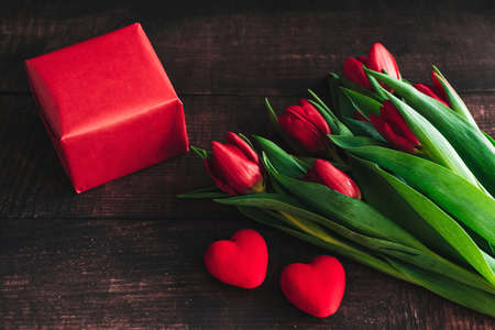 Bouquet of red tulips on a wooden background. Spring flowers. Mothers Day background.の写真素材