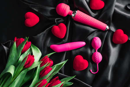 Various sex toys set on a black background. Advertising a sex shop. The view from the top. Spring. Tulipsの写真素材