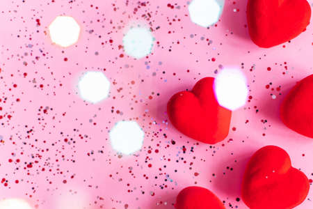 Red hearts on pink background with confetti. Valentines Day template with copy spaceの写真素材