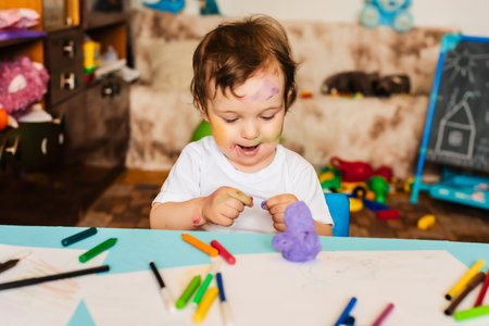 the boy is engaged in modeling from dough for modeling figuresの写真素材