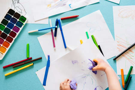 childrens pens, colored pencils and markers and paints top viewの写真素材