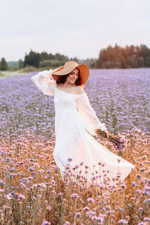 Provence blooming field. The girl enjoys life and gets pleasureの写真素材