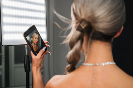 Shooting for social networks, an insider girl shoots an image made by a makeup artist and a hairdresser. Promotion in social networks. networks.の写真素材