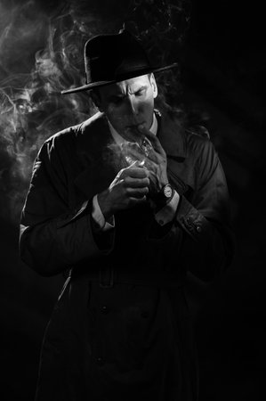 Dark noir portrait of a male detective lighting a cigarette. Private detective, spy, investigation...
