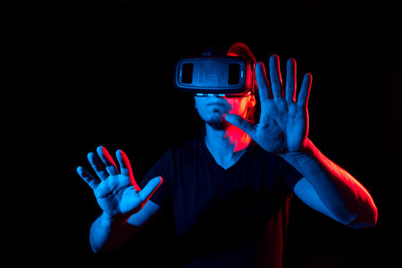 A young man using high-tech virtual reality glassesの写真素材