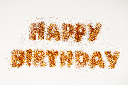 happy birthday inscription in bright sequins on white backgroundの写真素材