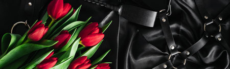Various sex toys set on a black background. The view from the top. Tulips. Valentines day. Horizontal wide photo subtitle, cover. copy-spaceの写真素材