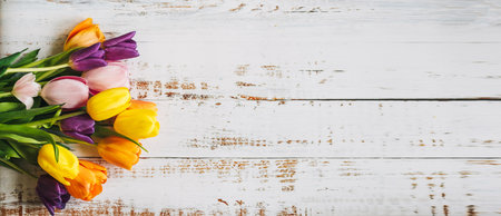 colorful tulips on a white wooden background. the view from the top. with space for textの写真素材