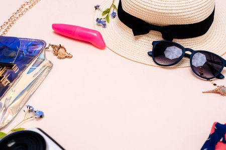 summer travel accessories. womens set of adult toys, camera, hat, glasses on a light background. space for your textの写真素材