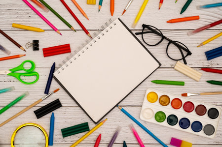 back to school soon. buying stationery, flatley, a place to copy your text or advertising. white wooden background.の写真素材