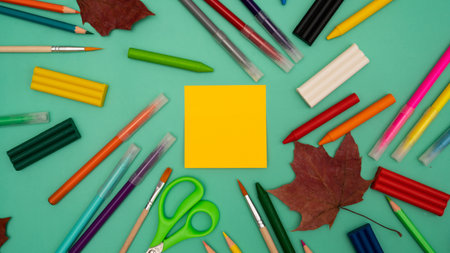 Back to school soon. buying stationery, flatley, a place to copy your text or advertising on a bright sticker. Bright background. photo 16:9の写真素材