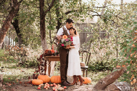 Gentle embrace of lovers a man embraces a girl with a bouquet in her hands.の写真素材