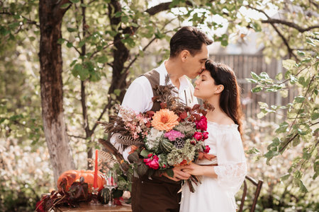 Gentle embrace of lovers a man embraces a girl with a bouquet in her hands.の写真素材