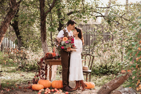 Gentle embrace of lovers a man embraces a girl with a bouquet in her hands.の写真素材
