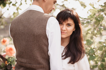 Romantic mood. A man in love gently embraces his girlfriend.の写真素材