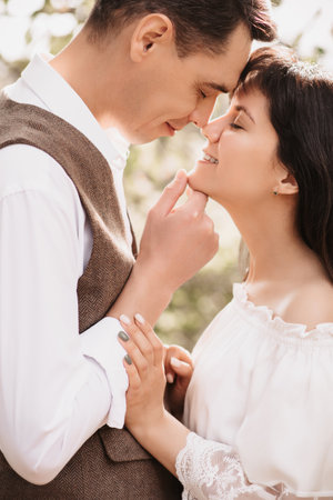 Romantic mood. A man in love gently embraces his girlfriend.の写真素材