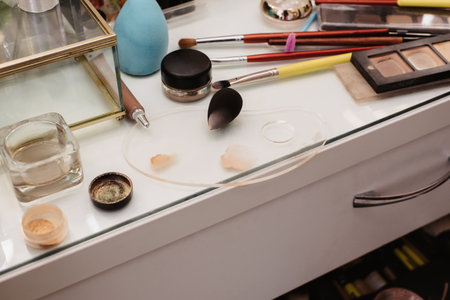 Shooting in a beauty salon. A snapshot of the makeup artists workplace with professional cosmetics and brushes laid out.の写真素材