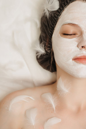 Top view of the client relaxing in the cosmetologists office with a mask on her faceの写真素材