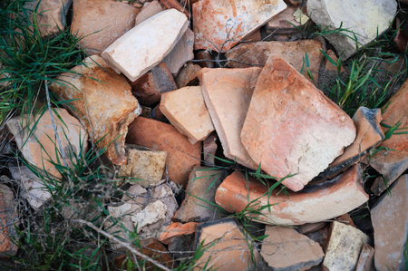 Shattered pottery, pieces of destroyed pottery, remnants of defective and damaged, ceramic, stoneware near a working pottery facilityの写真素材