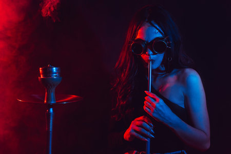 Hookah atmosphere. The girl enjoys smoking a hookah, sheesha. Surrealismの写真素材